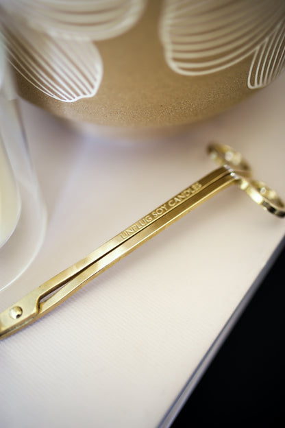 Close-up of Unplug wick trimmer showing engraved detail